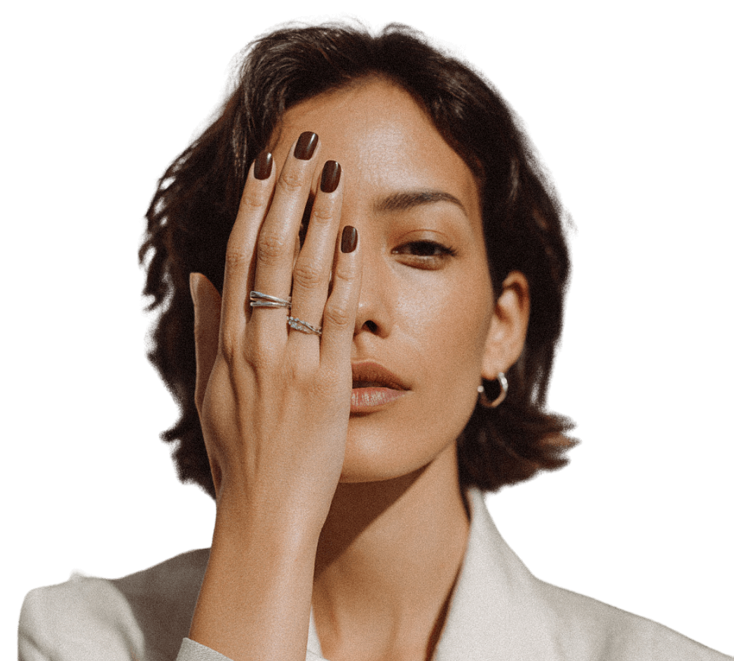 Editorial portrait — woman in cream blazer, hand resting near her face